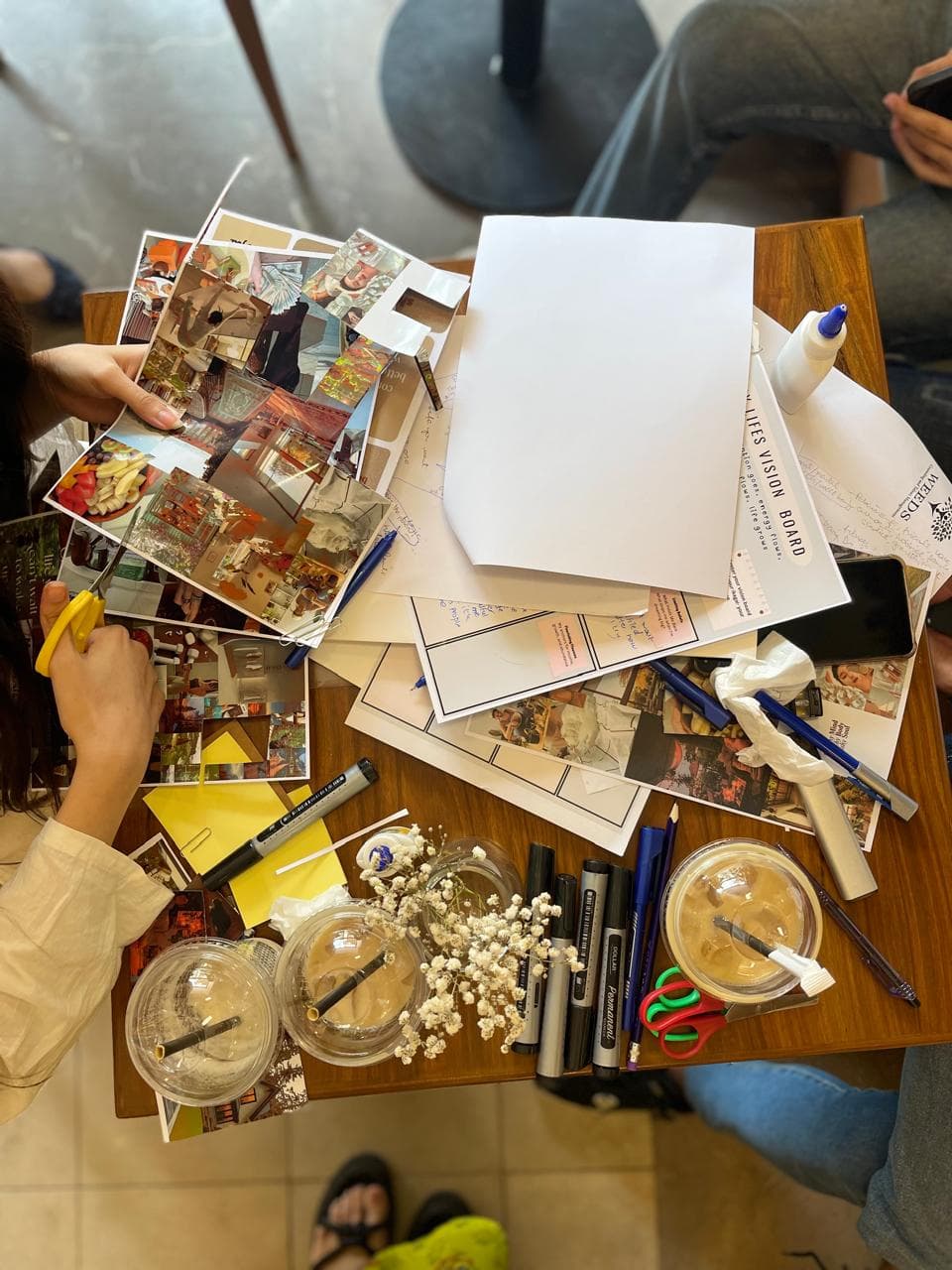 Cutting collage images at a Self Studio vision board workshop